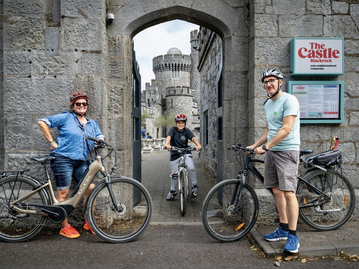 Esther McCarthy, Scott Read and James Foley leave Blackrock Castle Observatory after visiting its historic turret as part of the Beyond the Glass Adventure Tours cycling experience. Picture: Chani Anderson