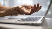 Woman massaging painful wrist at work repetitive strain injury