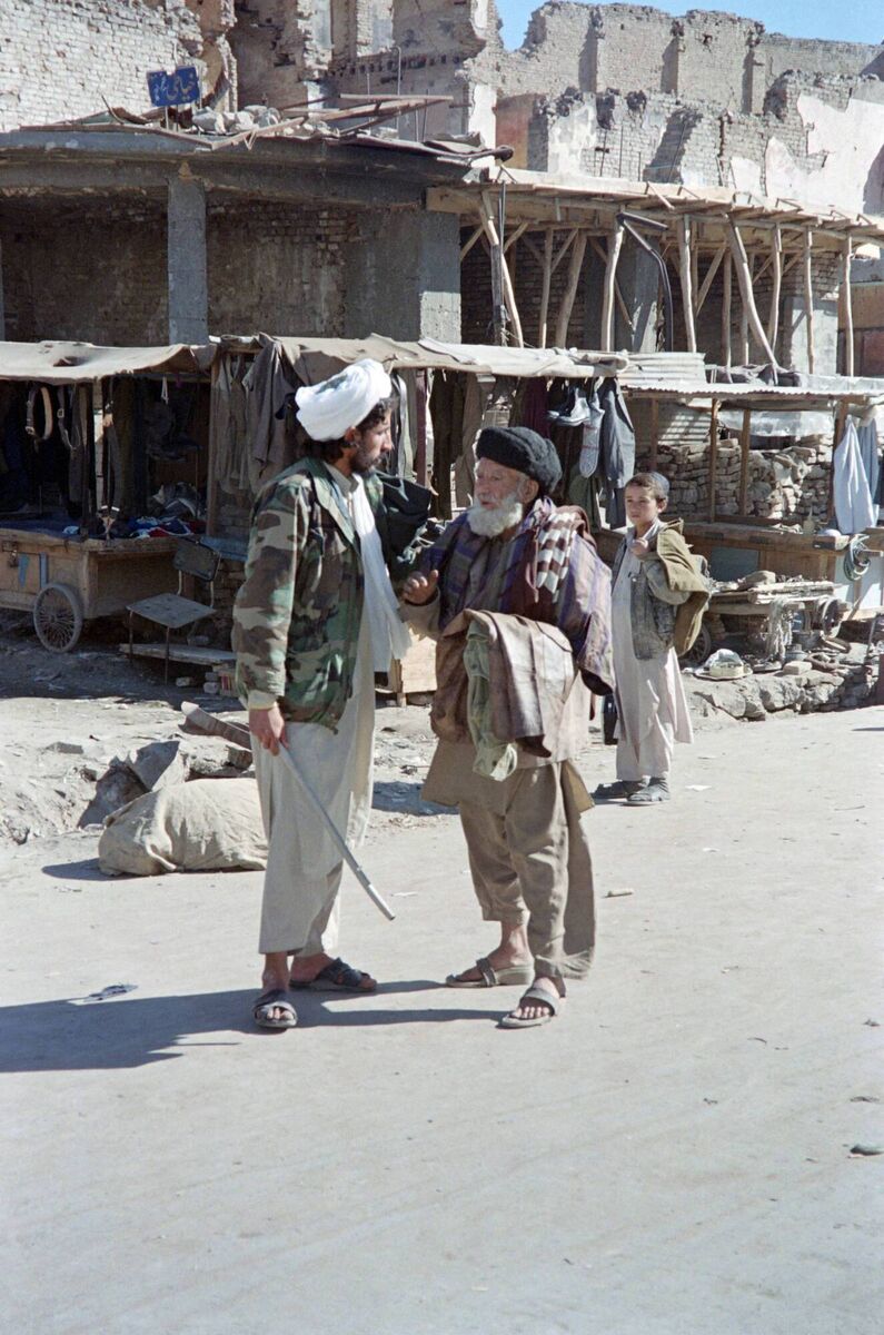 A soldier belonging to strict Moslem Taliban militia forces orders an elderly man to join the Friday noon prayer at Kabul's main Pul-i-Khishti mosque in 1996. Under the Taliban, men were banned from trimming their beards and women were required to wear the burqa. A soldier belonging to strict Moslem Taliban militia forces orders an elderly man to join the Friday noon prayer at Kabul's main Pul-i-Khishti mosque in 1996. Under the Taliban, men were banned from trimming their beards and women were required to wear the burqa.