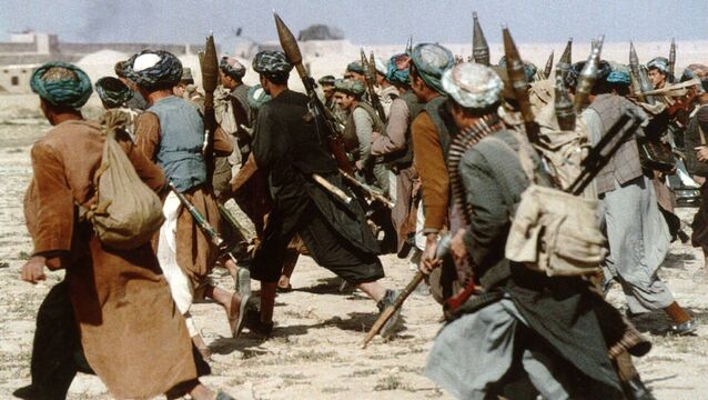 <p>Soldiers of the anti-Taliban alliance infantry of northern ethnic Uzbek warlord general Abdul Rashid Dostum launch an assault on Kabul in 1996. Pictures: Getty Images</p>
