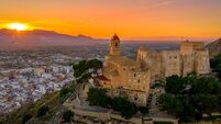 Aerial sunset panorama view of Cullera castle and popular seaside resort vacation town near Valencia Spain