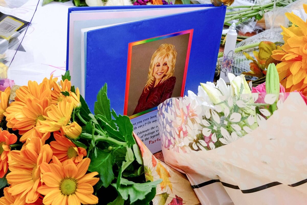 A book from the late Dolly Parton's Imagination Library programme among flowers left at a memorial to the singer-songwriter in her hometown of Sevierville, Tennessee. Picture: Michael Mathes/Getty Images