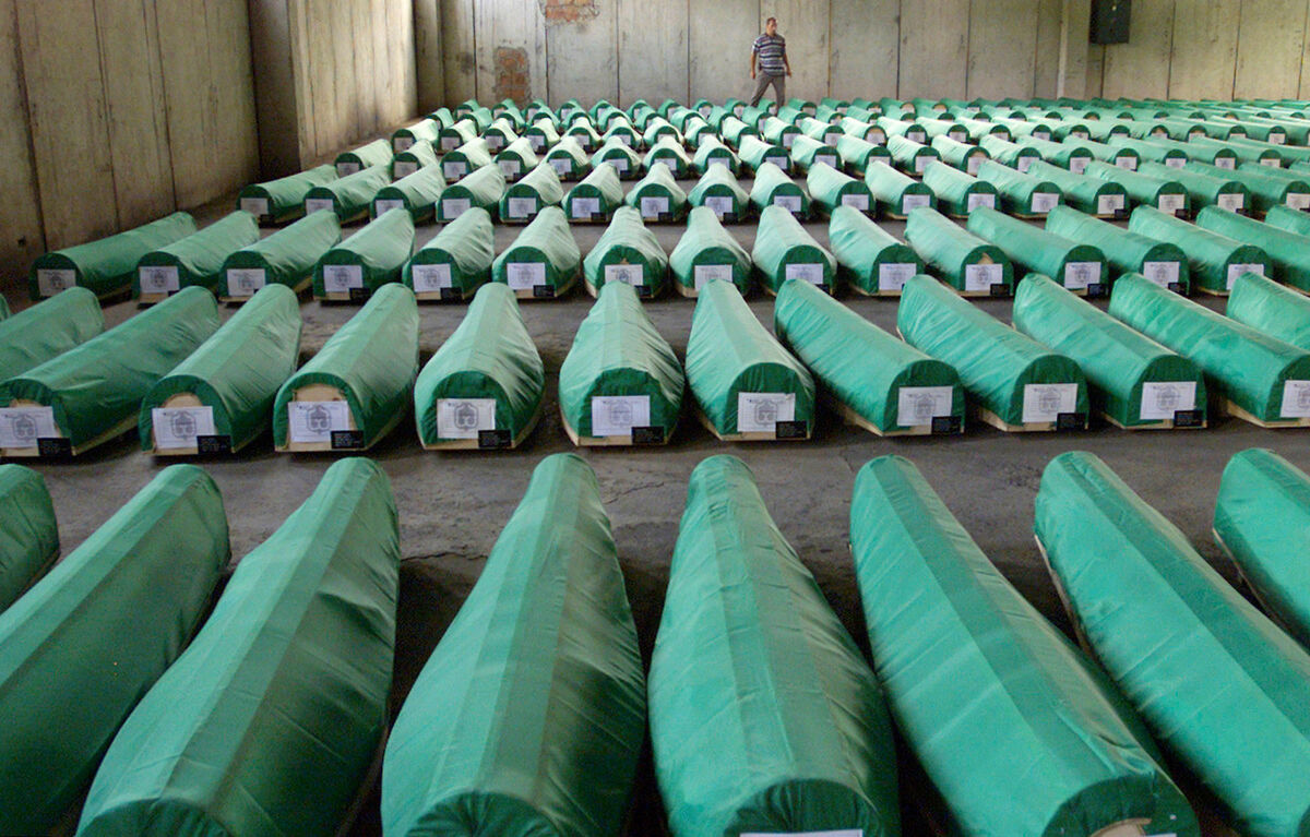 A Bosnian man looks at the identified covered bodies of 282 Srebrenica victims at an abandoned factory hangar in Potocari near Srebrenica, Bosnia. Picture: Amel Emric/AP A Bosnian man looks at the identified covered bodies of 282 Srebrenica victims at an abandoned factory hangar in Potocari near Srebrenica, Bosnia. Picture: Amel Emric/AP