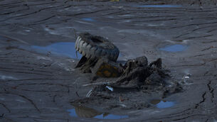 A half submerged lorry on the bank of the Trishuli River (Niranjan Shrestha/AP)