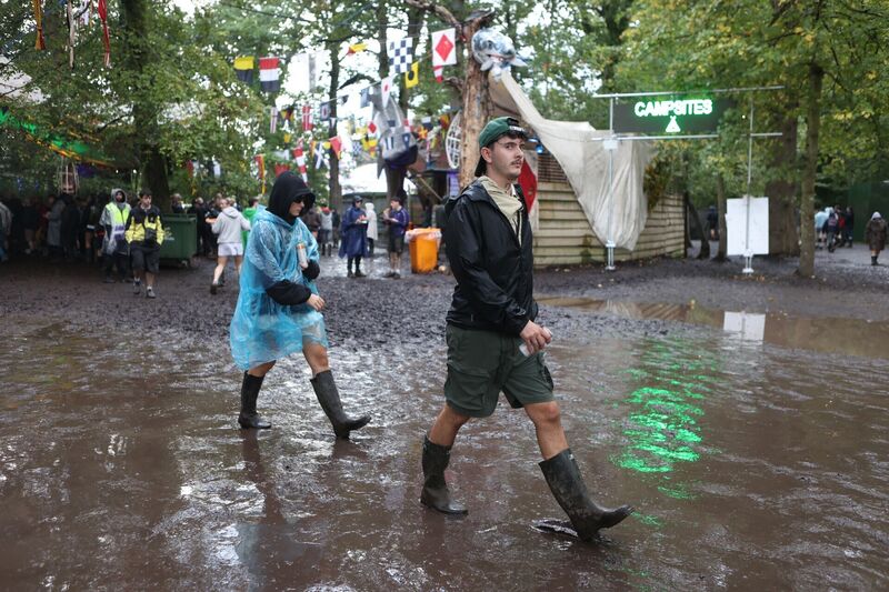 WET WET WET: Festivalgoers wade through the puddles during the final day of Electric Picnic 2026 at Stradbally in Co Laois. Picture: Evan Treacy/PA