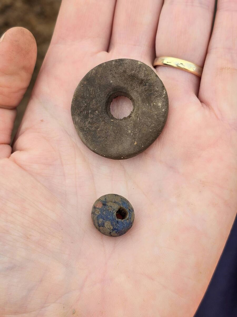 A stone spindle whorl and a blue glass bead which were recovered in EirGrid excavation at Moanlahan, south of Killeagh, Co Cork. A stone spindle whorl and a blue glass bead which were recovered in EirGrid excavation at Moanlahan, south of Killeagh, Co Cork.