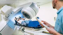 Cancer treatment in a modern medical private clinic or hospital with a linear accelerator. Professional doctors team working whi