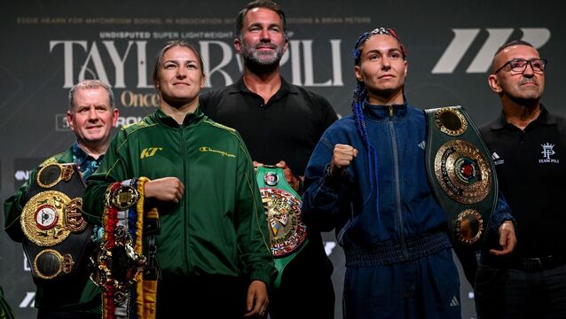 <p>Katie Taylor and Flora Pili, right, square-off in the company of Brian Peters, Katie Taylor's manager, left, and Matchroom Boxing promoter Eddie Hearn. Pic: Stephen McCarthy/Sportsfile</p>