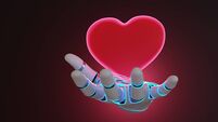 Robotic arm having a glowing red heart floating above its palm on dark background. Illustration of the concept of emotion artifi