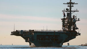 <p>Sailors and Marines line the deck of aircraft carrier USS Abraham Lincoln (CVN-72) as it deploys from San Diego, Jan. 3, 2021. (K.C. Alfred/The San Diego Union-Tribune via AP, File)</p>