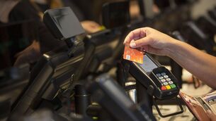 <p>A customer uses a credit card to make a contactless payment. Picture: Simon Dawson/Bloomberg</p> <p>A customer uses a credit card to make a contactless payment. Picture: Simon Dawson/Bloomberg</p>