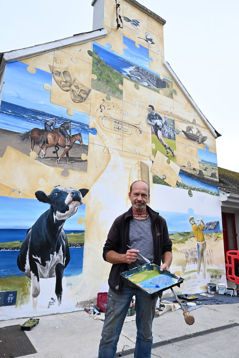 Artist Marcus Vallboehmer is painting a gable-wall mural in the village of Doonbeg ahead of the Irish Open. Artist Marcus Vallboehmer is painting a gable-wall mural in the village of Doonbeg ahead of the Irish Open.