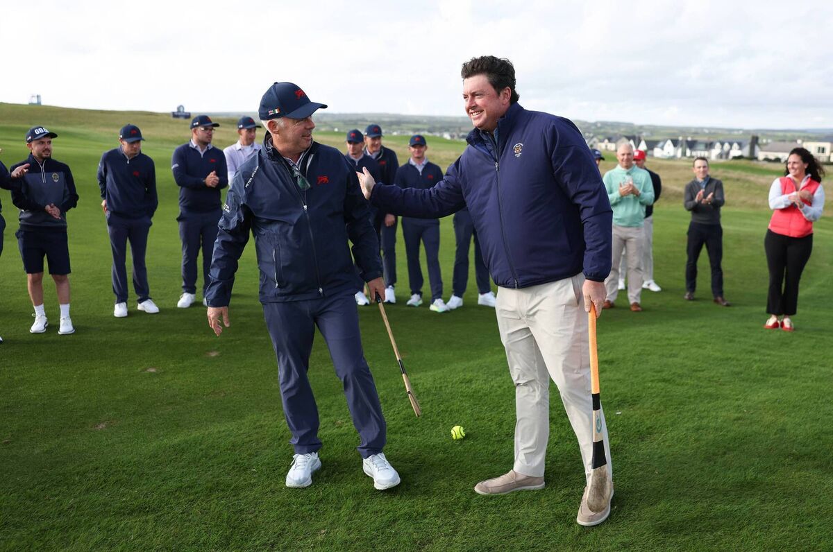 Team GB&I Captain Dean Robertson with Team USA Captain Nathan Smith during a hurling clinic hosted by players from the Clare hurling team prior to the Walker Cup at Lahinch Golf Club. Pic: Oisin Keniry/R&A/R&A via Getty Images. Team GB&I Captain Dean Robertson with Team USA Captain Nathan Smith during a hurling clinic hosted by players from the Clare hurling team prior to the Walker Cup at Lahinch Golf Club. Pic: Oisin Keniry/R&A/R&A via Getty Images.