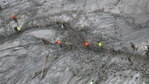 <p>A drone view shows rescue workers inspecting damaged structures amid sludge, debris and landslides in the aftermath of flash flooding along the Trishuli River in the Devighat area of Nepal's Nuwakot district, Saturday, Aug. 29, 2026. (AP Photo/Rajesh Kumar Singh)</p>