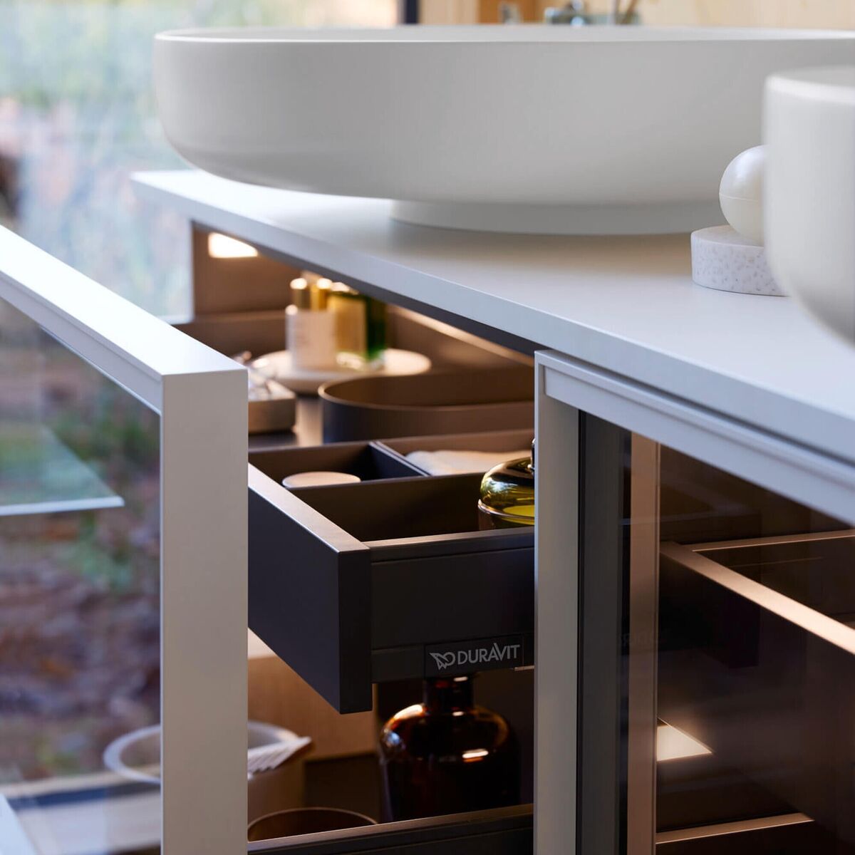 The shallow Duravit Vitrium basin (Latin for glass) does not require a low vanity and therefore does not drive the vanity height down, or impinge on the storage beneath. Priced from €1,100 in white and variety of matte colours, various suppliers.