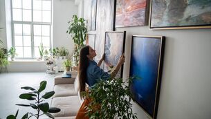 <p>Grouping artwork is an enriching, creative moment to enjoy. Ensure your wall fixings match the weight of the piece. Picture: iStock</p>