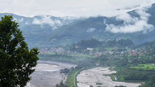 Structures partially submerged in mud brought in by flash floods in Nepal (Rajesh Kumar Singh/AP)