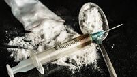 A drug syringe and a spoon with cooked heroin