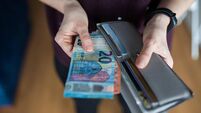 Woman taking out money from wallet