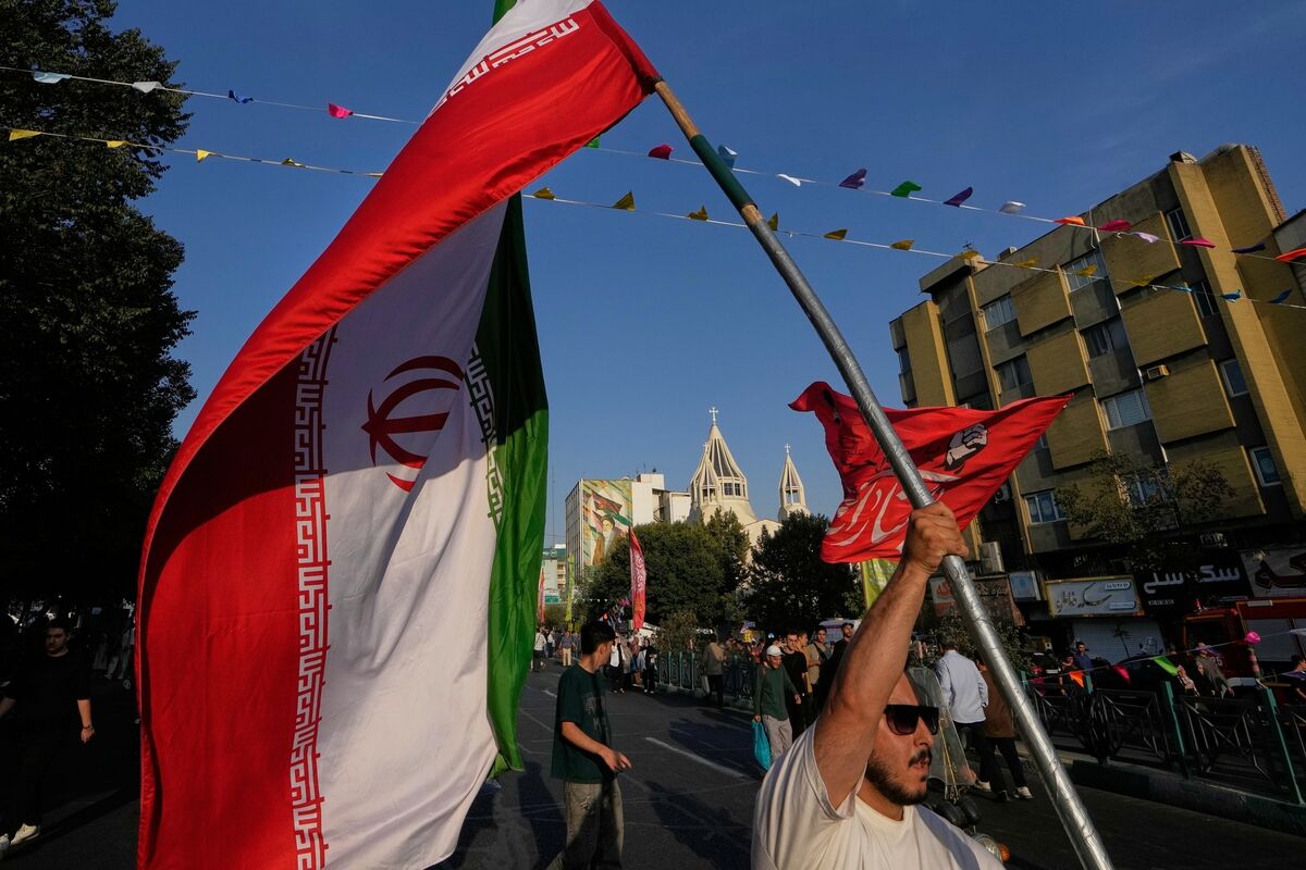 A man holds an Iranian flag during a street celebration marking Prophet Muhammad's birthday, with St. Sarkis Armenian Cathedral in the background, in Tehran, Sunday, Aug. 30, 2026. (AP Photo/Vahid Salemi) A man holds an Iranian flag during a street celebration marking Prophet Muhammad's birthday, with St. Sarkis Armenian Cathedral in the background, in Tehran, Sunday, Aug. 30, 2026. (AP Photo/Vahid Salemi)