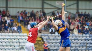 <p>Carrigaline’s Dave Griffin gets to the high ball ahead of Kilworth Will Condon. Pic: Noel Sweeney</p>