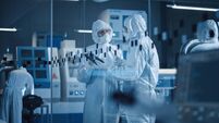 Factory Cleanroom: Engineer and Scientist Wearing Coveralls, Standing in Workshop Talk and Use Tablet Computer, Professionals De