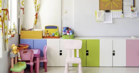 Kindergarten Classroom With Table and Colorful Chairs