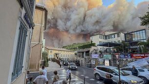 <p>Bystanders watch the smoke and flames from a wildfire on July 21 this year in Cotignac, France. The UN's World Meteorological Organization is warning that success at curbing air pollution is being negated by wildfires. Picture: FBM Media/Getty</p>