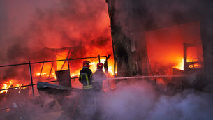 Firefighters try to extinguish a fire following a Russian missile attack in Kyiv, Ukraine (Francisco Seco/AP) Firefighters try to extinguish a fire following a Russian missile attack in Kyiv, Ukraine (Francisco Seco/AP)
