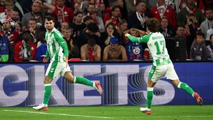 <p>Real Betis' Irish forward Troy Parrott celebrates with Rodrigo Riquelme. Pic: Sameer AL-DOUMY / AFP via Getty Images</p>