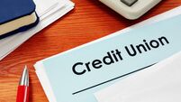 Credit Union papers for loan on desk.