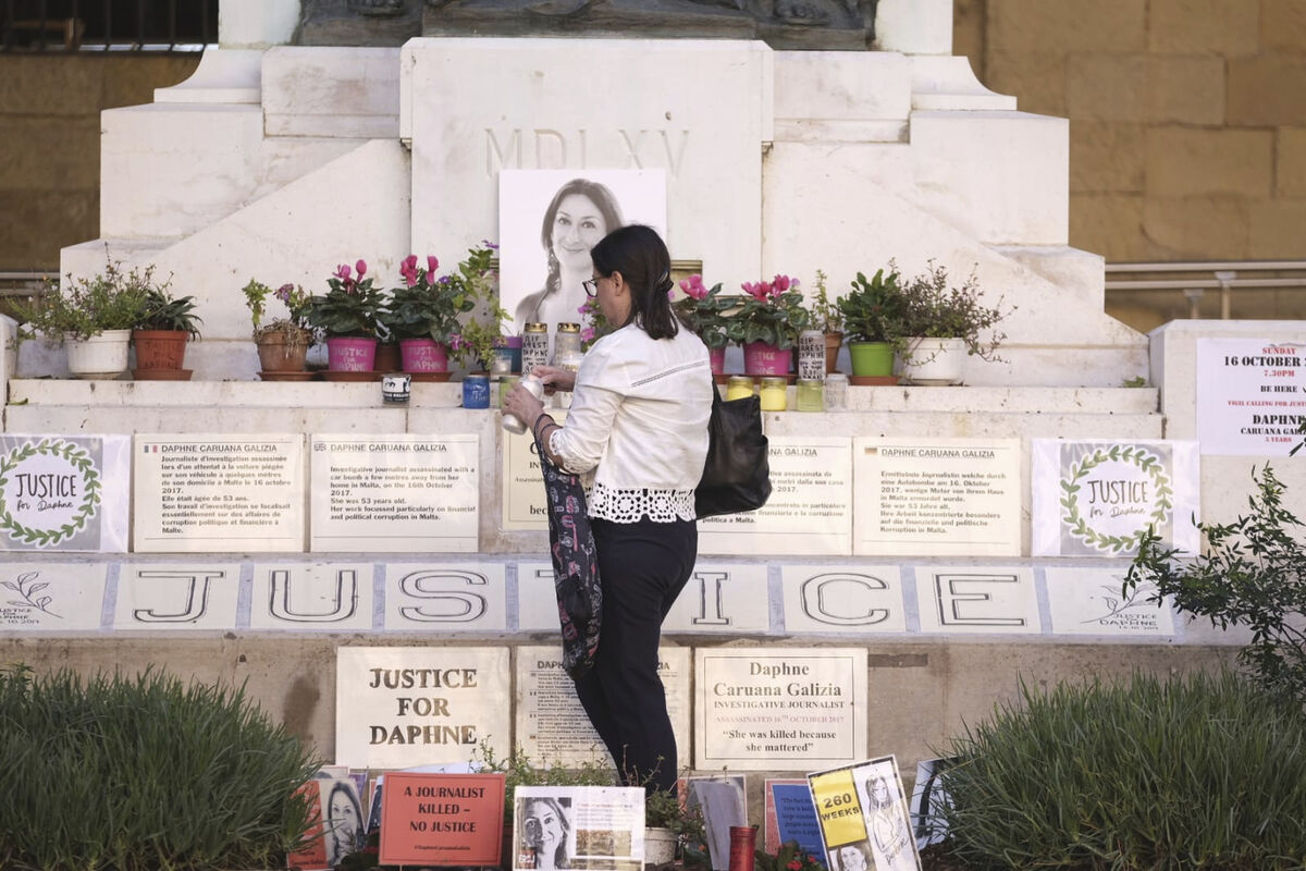 Mandy Mallia, sister of late journalist Daphne Caruana Galizia, lights candles in front of a picture of her sister in Valletta, Malta, Friday, Oct. 14, 2022. The first trial for the car-bomb assassination of a Maltese journalist who investigated corruption in the tiny Mediterranean island nation has begun. (AP Photo/Jonathan Borg) Mandy Mallia, sister of late journalist Daphne Caruana Galizia, lights candles in front of a picture of her sister in Valletta, Malta, Friday, Oct. 14, 2022. The first trial for the car-bomb assassination of a Maltese journalist who investigated corruption in the tiny Mediterranean island nation has begun. (AP Photo/Jonathan Borg)