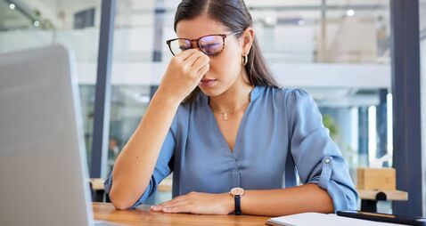Stress headache, burnout and woman in office overwhelmed with workload at desk with laptop. Frustrated, overworked and tired wom
