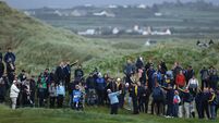 Shane Lowry plays out of the rough on the eighteenth 10/9/2026
