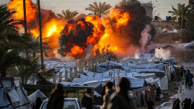 <p>A fireball erupts following an Israeli strike near a tent encampment sheltering people displaced by war in Deir el-Balah in the central Gaza Strip on March 25. Picture: Eyad Baba/AFP/Getty</p>