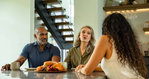 Dining Room Conversation with Mother Talking to Daughter While Father Listens