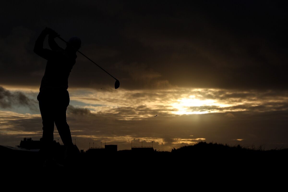 Rory McIlory tees off at the 18th on Doonbeg as the sun sets over the course on Thursday. Photo: INPHO/Ben Brady