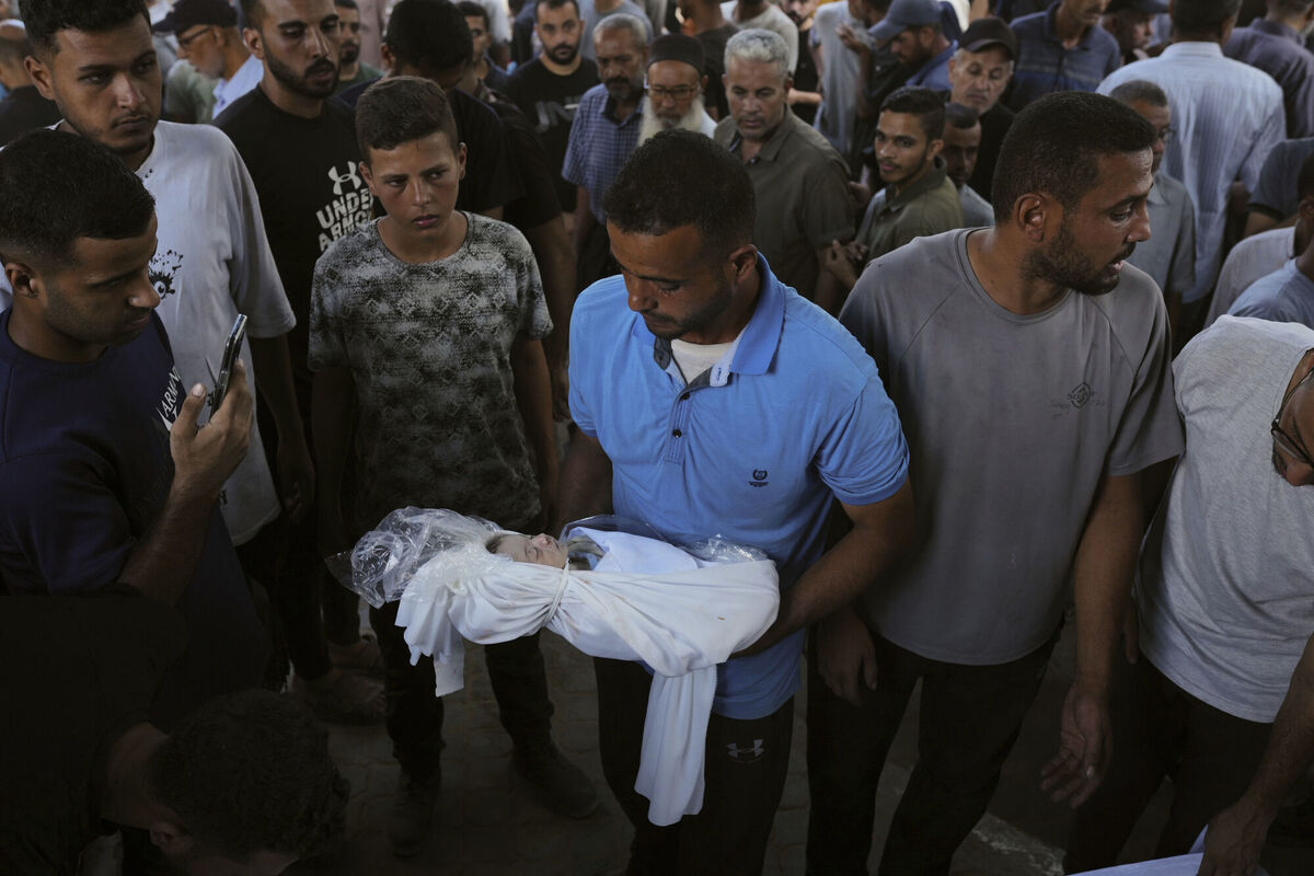 A relative carries the body of Palestinian infant Jabr Al-Ashhab, who was killed in an Israeli military strike, during his funeral outside Shifa Hospital in Gaza City, on September 4, 2025. Picture: Jehad Alshrafi/AP