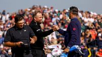 Shane Lowry shakes hands with Pádraig Harrington after finishing his round on the eighteenth green 11/9/2026
