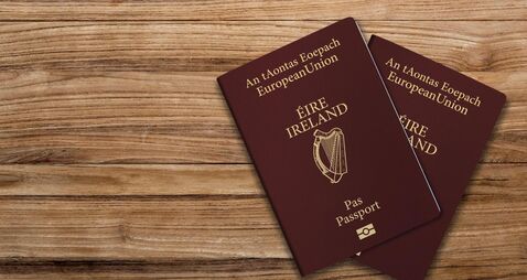 2GJW6EE An Irish passport gives citizens of Ireland, a top view of passports on a wooden table