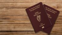 2GJW6EE An Irish passport gives citizens of Ireland, a top view of passports on a wooden table