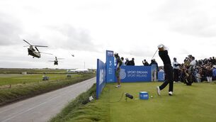 <p>Haotong Li prepares to tee-off as United States Army Boeing CH-47F Chinook helicopters take off after the arrival of US President Donald Trump at the Irish Open. Pic: Damien Eagers/PA Wire.</p>