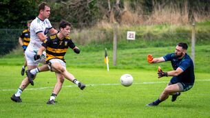 <p>Ilen Rovers‘ Damien O’ Sullivan protects his net against Buttevant’s Billy O’Riordan. Pic: Chani Anderson</p>
