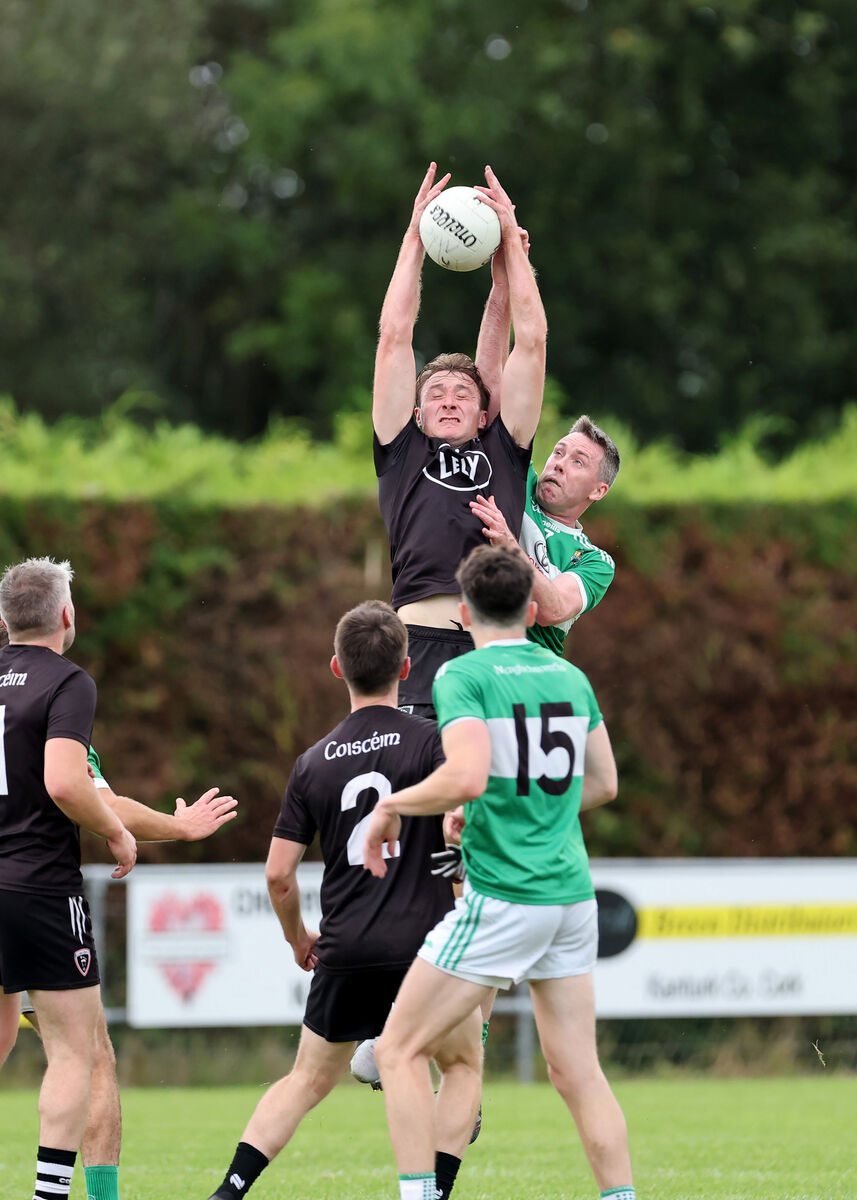 Sean Meehan, Kiskeam, Sean Kiely, Macroom, battle for the high ball. Pic: Jim Coughlan. Sean Meehan, Kiskeam, Sean Kiely, Macroom, battle for the high ball. Pic: Jim Coughlan.