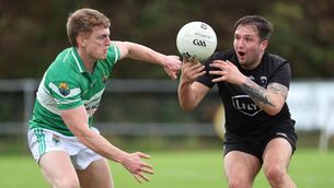 <p>Kiskeam's Kieran O'Connor in action against Macroom's Alan Quinn. Pic: Jim Coughlan.</p>