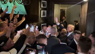 <p>Donald Trump walks through the members' bar of his Doonbeg golf resort on Saturday night. Picture: Claudia Savage/PA Wire</p>