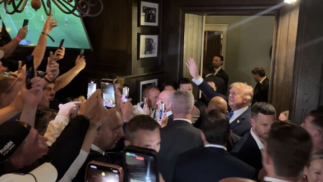 <p>Donald Trump walks through the members' bar of his Doonbeg golf resort on Saturday night. Picture: Claudia Savage/PA Wire</p>