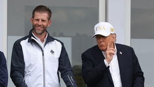 <p>US President Donald Trump with his son Eric Trump (Damien Eagers/PA)</p>