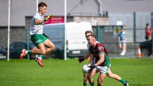 <p>HONOURS EVEN: Kanturk's Ryan Walsh goes high in defence. Pic: Chani Anderson.</p>