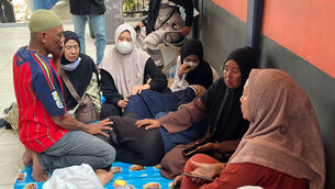 People are waiting for news on their relatives who were among the passengers of the ferry that overturned in bad weather in the Java Sea (AP)